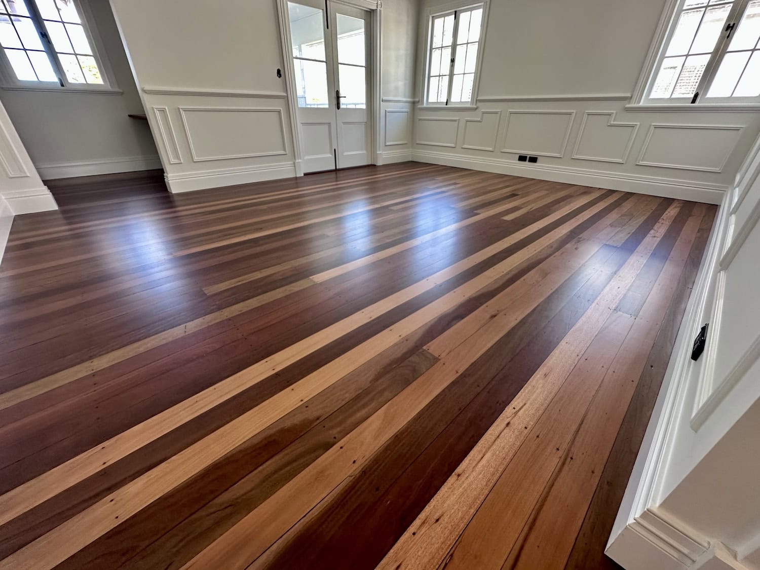 Elegant hardwood flooring installation in a bright living room — example finish for Kenmore timber floors