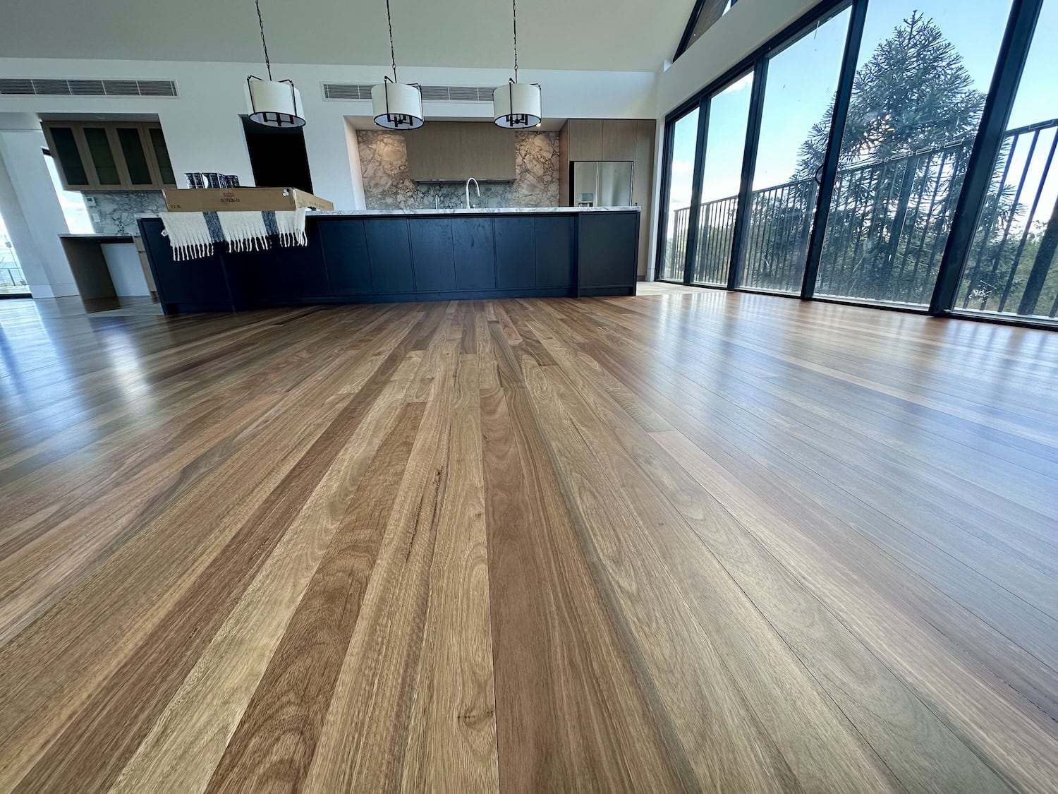 Wooden flooring installation in a modern kitchen and living area in Clayfield Brisbane