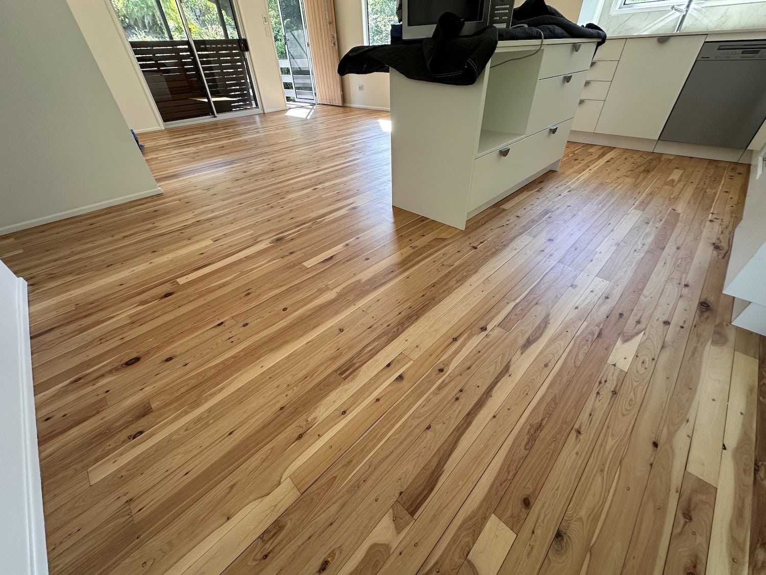 Wooden flooring installation in a modern kitchen and dining area — Kenmore floor sanding job