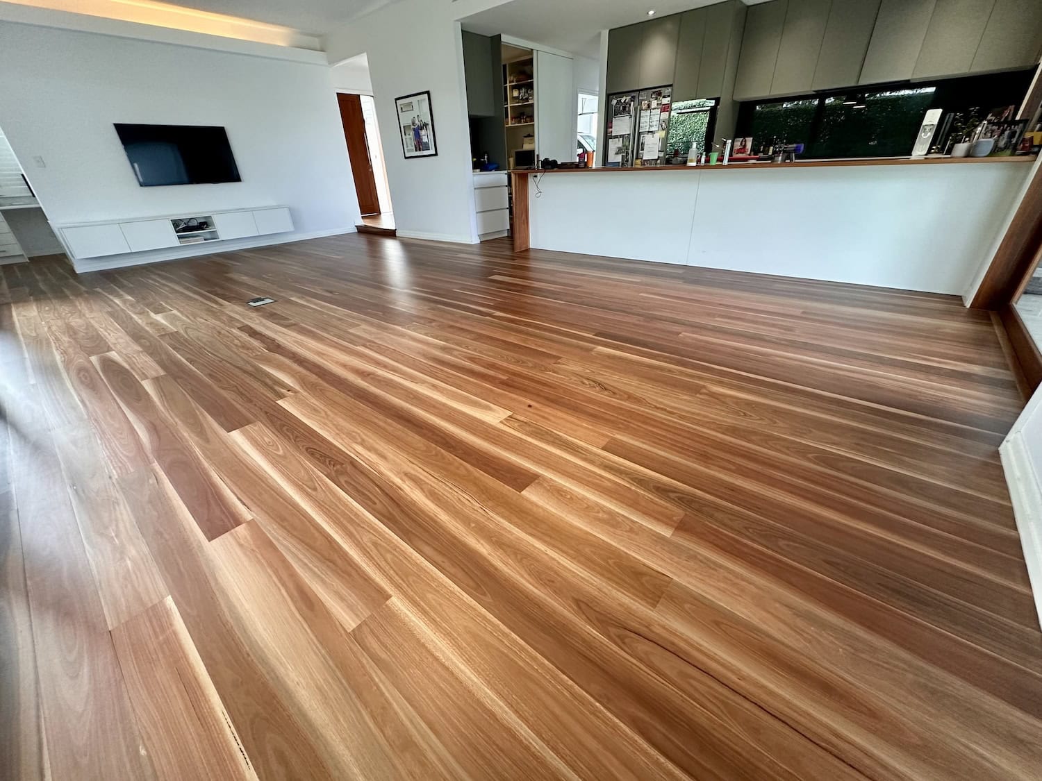 Beautiful hardwood flooring in a contemporary open-plan living area in Holland Park Brisbane